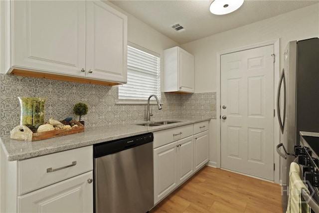 127 Laurel Green Ct, Savannah, GA 31419 - kitchen featuring dishwasher, light wood-style floors, white cabinetry, decorative backsplash, and light stone countertops