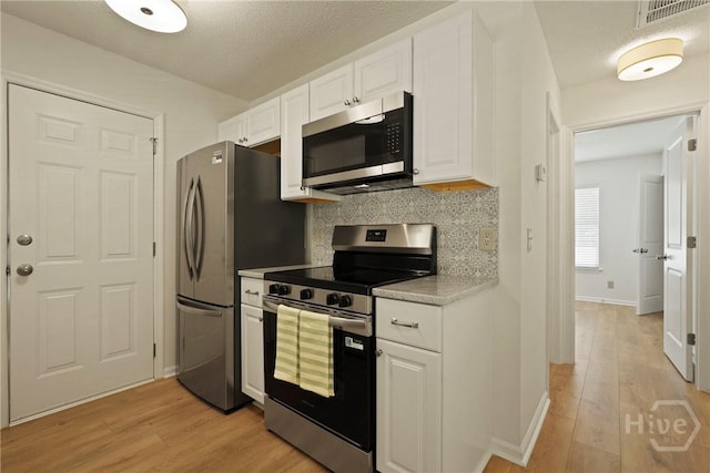 127 Laurel Green Ct, Savannah, GA 31419 - kitchen with appliances with stainless steel finishes, light wood finished floors, white cabinetry, and backsplash