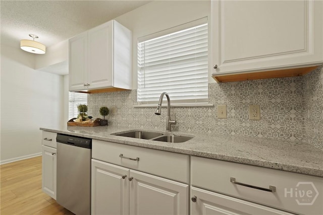127 Laurel Green Ct, Savannah, GA 31419 - kitchen featuring dishwasher, decorative backsplash, light wood-type flooring, white cabinetry, and a textured ceiling
