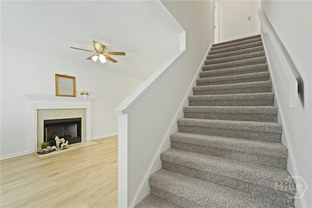 127 Laurel Green Ct, Savannah, GA 31419 - stairway with wood finished floors, a ceiling fan, and a tile fireplace