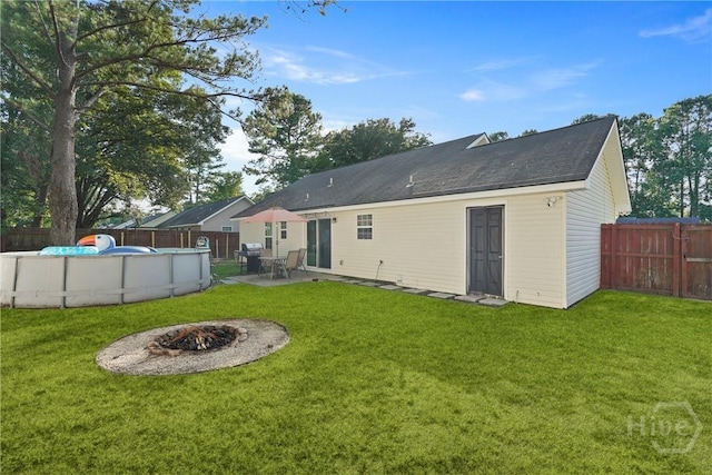 217 Bailee Ave, Rincon, GA 31326 - rear view of house featuring a fenced backyard, an outdoor fire pit, and a patio area
