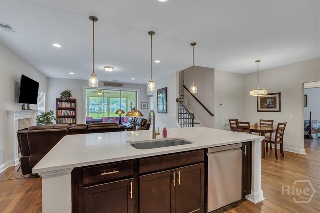 115 Merribee Ln, Pooler, GA 31322 - kitchen featuring stainless steel dishwasher, light countertops, light wood finished floors, open floor plan, and pendant lighting