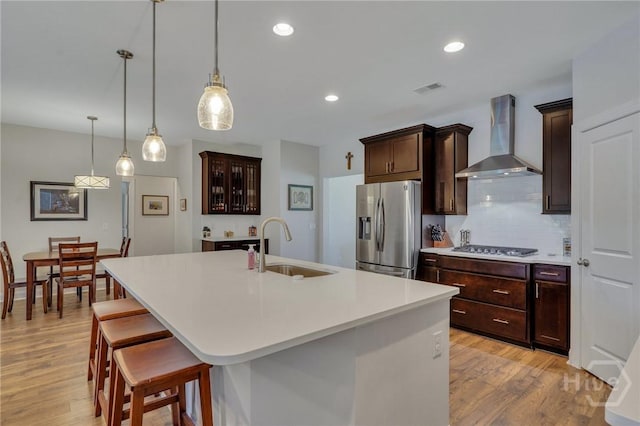 115 Merribee Ln, Pooler, GA 31322 - kitchen featuring stainless steel appliances, wall chimney range hood, light wood-type flooring, light countertops, and recessed lighting