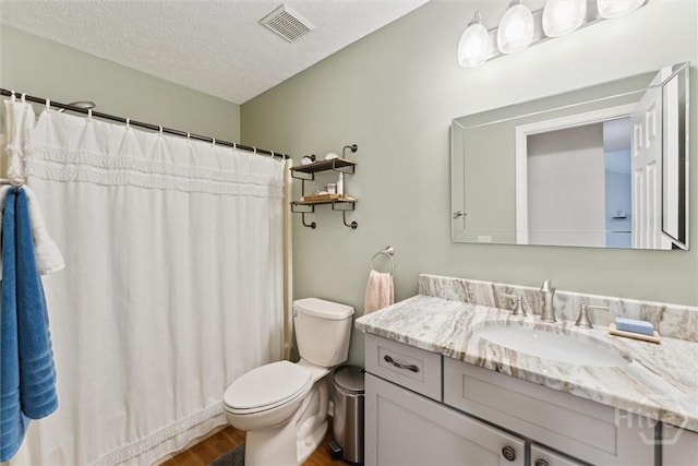 3 Watford Rd, Savannah, GA 31419 - full bathroom featuring wood finished floors, vanity, a textured ceiling, and a shower with shower curtain