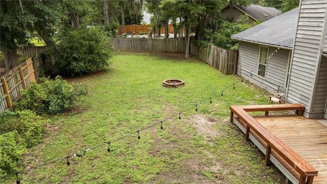 3 Watford Rd, Savannah, GA 31419 - fenced backyard with a wooden deck and an outdoor fire pit