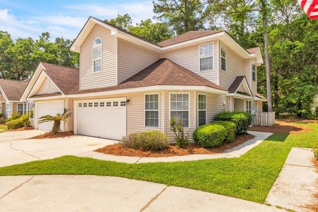 24 Marsh Hen Ct, Richmond Hill, GA 31324 - traditional-style house featuring concrete driveway, roof with shingles, an attached garage, and a front lawn
