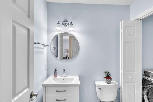 24 Marsh Hen Ct, Richmond Hill, GA 31324 - bathroom featuring washer / clothes dryer and vanity