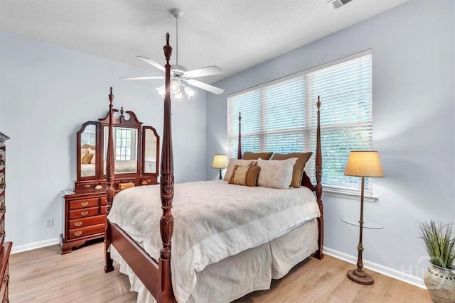 24 Marsh Hen Ct, Richmond Hill, GA 31324 - bedroom with light wood-style flooring and a ceiling fan