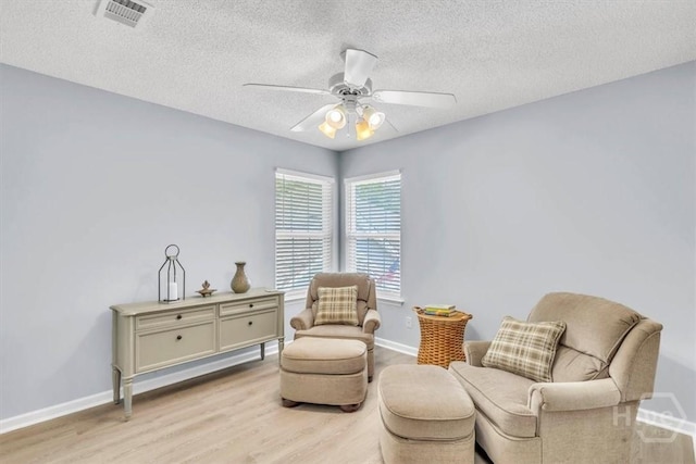24 Marsh Hen Ct, Richmond Hill, GA 31324 - living area with light wood-style floors, a ceiling fan, and a textured ceiling