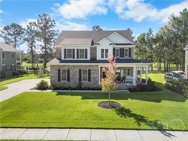176 Trail Creek Ln, Savannah, GA 31405 - craftsman-style house featuring a porch, a front lawn, brick siding, and driveway