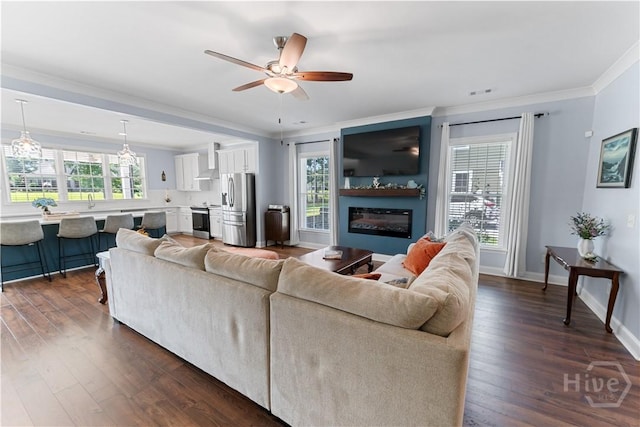 176 Trail Creek Ln, Savannah, GA 31405 - living area with crown molding, dark wood-style flooring, ceiling fan, and a glass covered fireplace