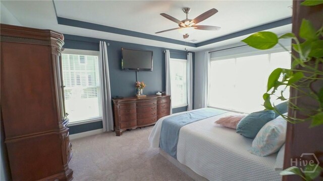 176 Trail Creek Ln, Savannah, GA 31405 - carpeted bedroom with a tray ceiling, multiple windows, and a ceiling fan