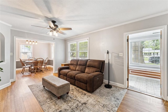 330 E 64th St, Savannah, GA 31405 - living room featuring ornamental molding, wood finished floors, ceiling fan, and arched walkways