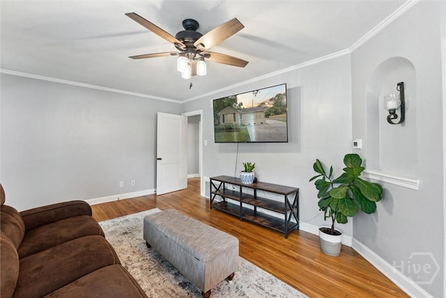 330 E 64th St, Savannah, GA 31405 - living room with crown molding, wood finished floors, ceiling fan, and arched walkways