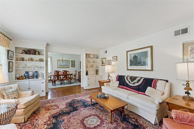 130 Hopecrest Ave, Savannah, GA 31406 - living room featuring a chandelier, wood finished floors, and built in features