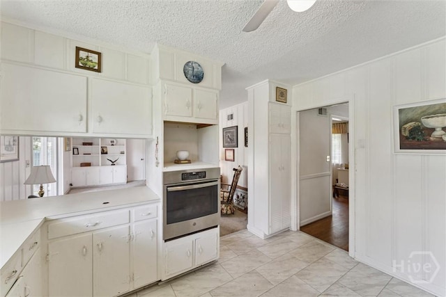 130 Hopecrest Ave, Savannah, GA 31406 - kitchen featuring oven, plenty of natural light, light countertops, a ceiling fan, and a textured ceiling