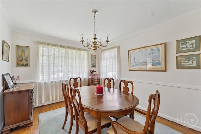 130 Hopecrest Ave, Savannah, GA 31406 - dining room with a chandelier, light wood-style floors, and crown molding