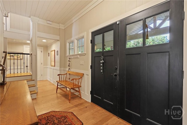 189 E 1st St, Midway, GA 31320 - foyer with stairway, ornamental molding, wood finished floors, and a decorative wall