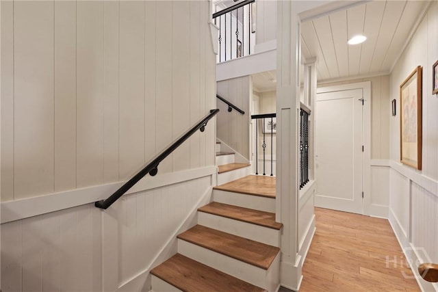 189 E 1st St, Midway, GA 31320 - stairs featuring wood finished floors, a decorative wall, and recessed lighting