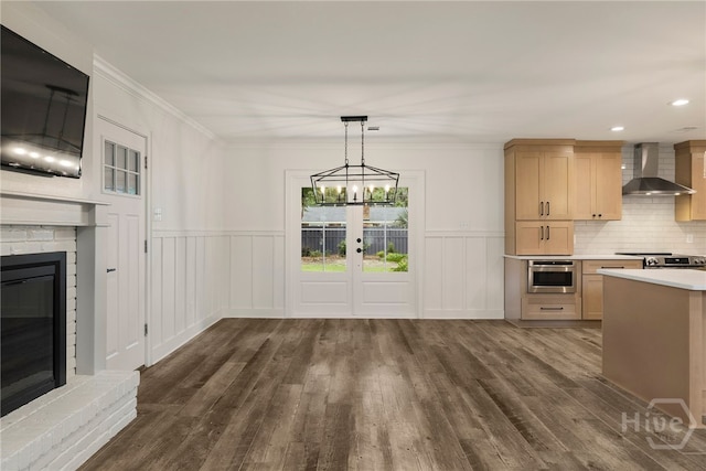 103 Kentshire Ct, Savannah, GA 31410 - kitchen featuring wall chimney exhaust hood, dark wood finished floors, light countertops, appliances with stainless steel finishes, and french doors