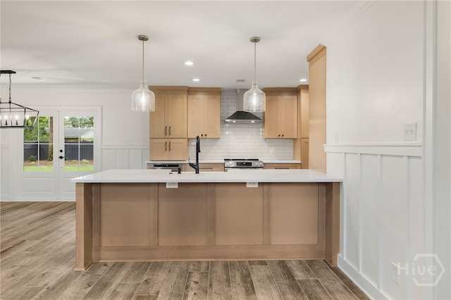 103 Kentshire Ct, Savannah, GA 31410 - kitchen featuring wall chimney range hood, stainless steel range with electric cooktop, light countertops, light wood-type flooring, and a decorative wall