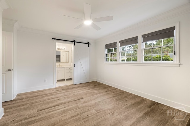 103 Kentshire Ct, Savannah, GA 31410 - unfurnished bedroom with a barn door, ornamental molding, light wood-style flooring, ensuite bath, and a ceiling fan