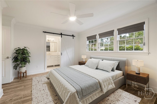 103 Kentshire Ct, Savannah, GA 31410 - bedroom featuring a barn door, crown molding, light wood-style floors, ensuite bath, and ceiling fan