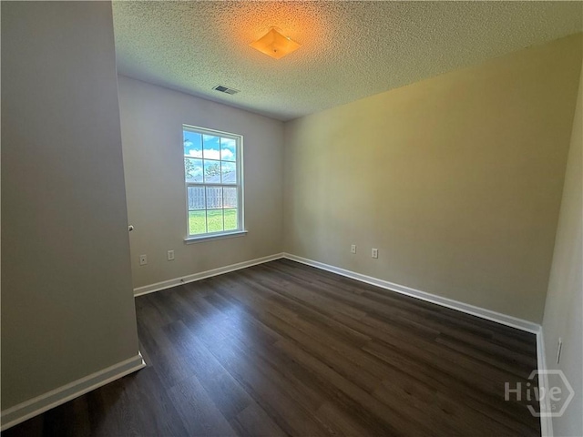 150 Knotty Pine Cir, Springfield, GA 31329 - empty room with dark wood-type flooring and a textured ceiling