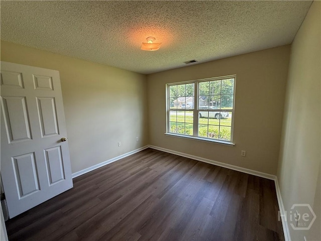 150 Knotty Pine Cir, Springfield, GA 31329 - unfurnished room with a textured ceiling and dark wood-type flooring