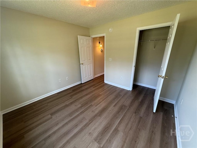 150 Knotty Pine Cir, Springfield, GA 31329 - unfurnished bedroom with dark wood-style floors, a closet, and a textured ceiling