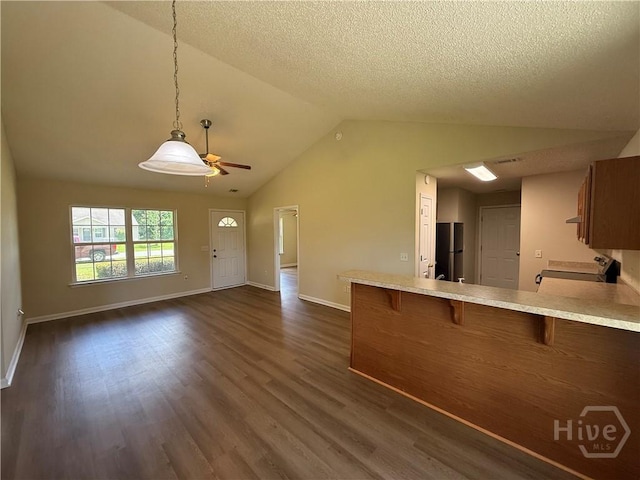 150 Knotty Pine Cir, Springfield, GA 31329 - kitchen featuring freestanding refrigerator, ceiling fan, light countertops, brown cabinets, and lofted ceiling