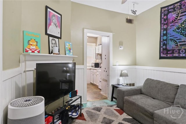 545 E Macon St, Savannah, GA 31401 - living room with a wainscoted wall, a decorative wall, and ceiling fan