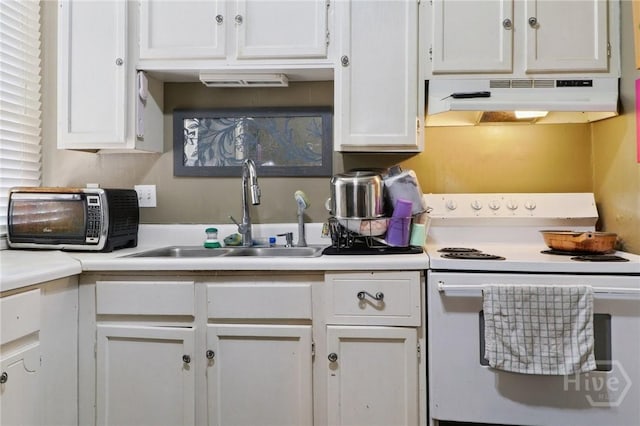 545 E Macon St, Savannah, GA 31401 - kitchen featuring white range with electric cooktop, under cabinet range hood, light countertops, and white cabinets