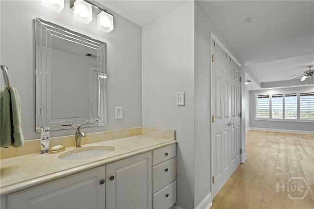 3113 River Dr Unit 10, Savannah, GA 31404 - bathroom with vanity, a ceiling fan, and wood finished floors