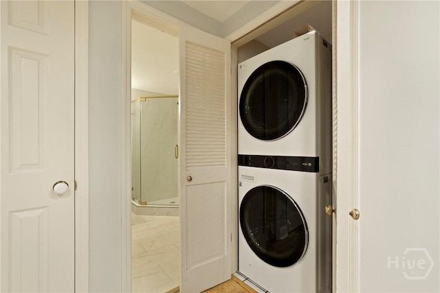 3113 River Dr Unit 10, Savannah, GA 31404 - laundry area featuring stacked washer and clothes dryer and light marble finish floors