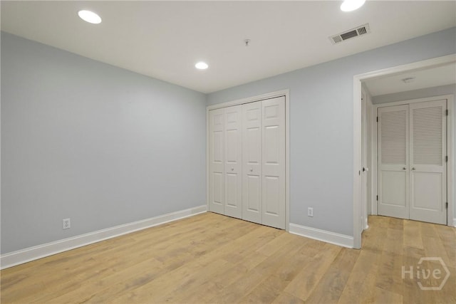 3113 River Dr Unit 10, Savannah, GA 31404 - unfurnished bedroom with light wood-style flooring, recessed lighting, and a closet