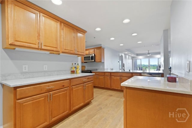 3113 River Dr Unit 10, Savannah, GA 31404 - kitchen with stainless steel microwave, a peninsula, ceiling fan, light wood-style flooring, and recessed lighting