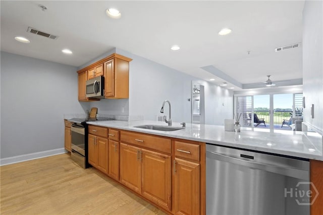 3113 River Dr Unit 10, Savannah, GA 31404 - kitchen with appliances with stainless steel finishes, light wood-style floors, a peninsula, a ceiling fan, and recessed lighting