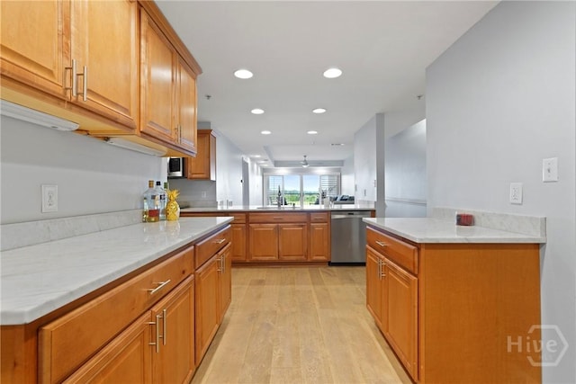 3113 River Dr Unit 10, Savannah, GA 31404 - kitchen featuring appliances with stainless steel finishes, light wood-type flooring, a peninsula, recessed lighting, and brown cabinetry