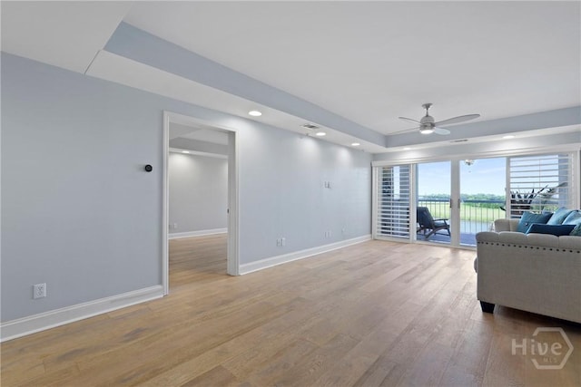 3113 River Dr Unit 10, Savannah, GA 31404 - living area featuring a raised ceiling, a ceiling fan, light wood-style flooring, and recessed lighting
