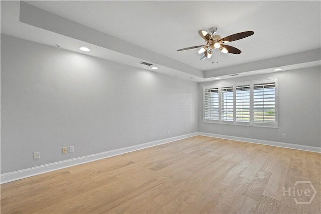 3113 River Dr Unit 10, Savannah, GA 31404 - spare room with recessed lighting, a ceiling fan, light wood finished floors, and a raised ceiling