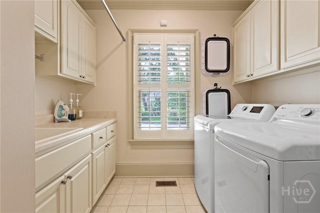 26 Little Comfort Rd, Savannah, GA 31411 - laundry room featuring cabinet space, washer and clothes dryer, and light tile patterned floors