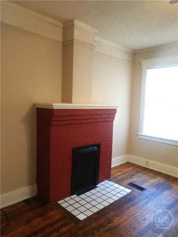908-910 E 34th St, Savannah, GA 31401 - unfurnished living room featuring wood finished floors, a brick fireplace, and crown molding