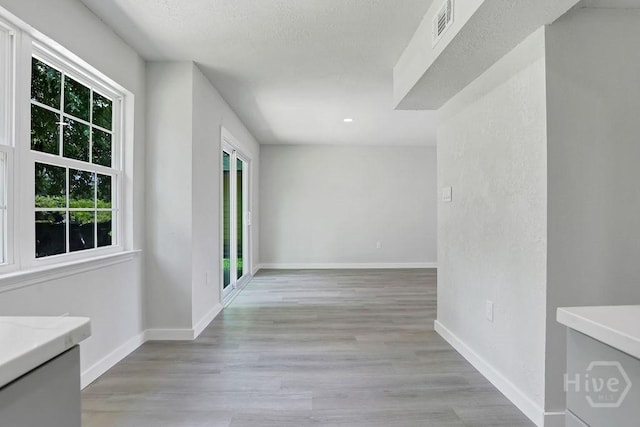 2204 Beaumont Dr, Savannah, GA 31406 - hall featuring light wood-style flooring and a textured ceiling