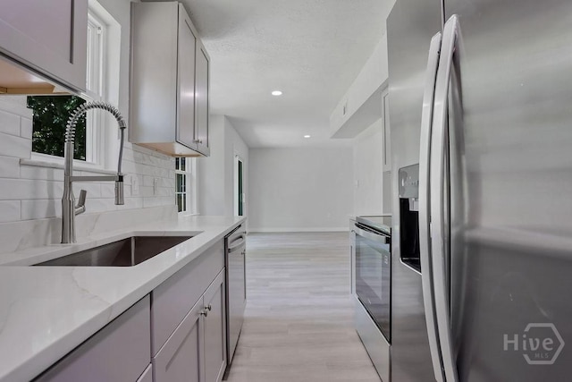 2204 Beaumont Dr, Savannah, GA 31406 - kitchen featuring appliances with stainless steel finishes, backsplash, light stone countertops, gray cabinetry, and recessed lighting