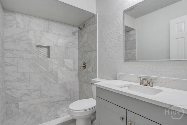 2204 Beaumont Dr, Savannah, GA 31406 - bathroom featuring vanity, tiled shower, and a textured wall