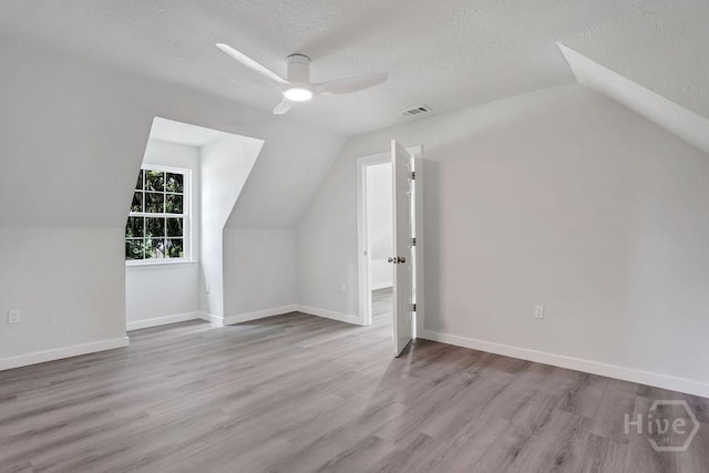 2204 Beaumont Dr, Savannah, GA 31406 - bonus room featuring lofted ceiling, wood finished floors, a textured ceiling, and a ceiling fan