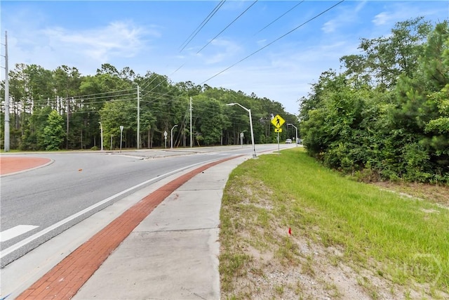 106 S Old Augusta Rd S, Rincon, GA 31326 - view of asphalt road with street lighting, sidewalks, and traffic signs
