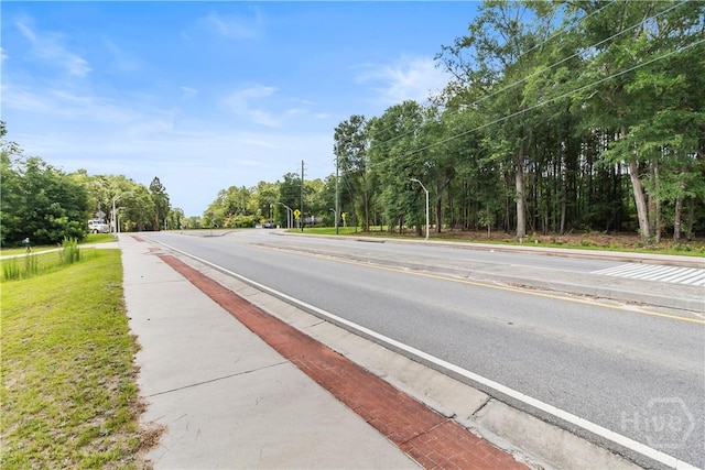 106 S Old Augusta Rd S, Rincon, GA 31326 - view of asphalt street with street lights, sidewalks, and curbs