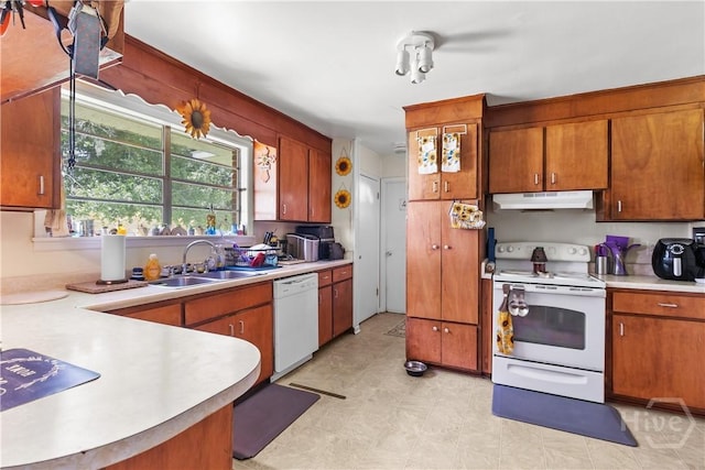106 S Old Augusta Rd S, Rincon, GA 31326 - kitchen with white appliances, under cabinet range hood, light countertops, and brown cabinets
